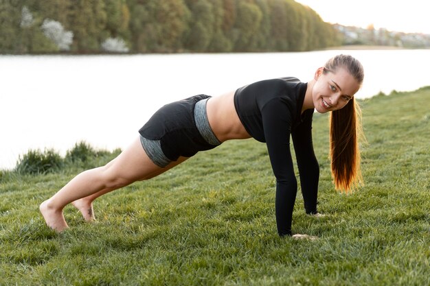 Blonde woman working out outdoors