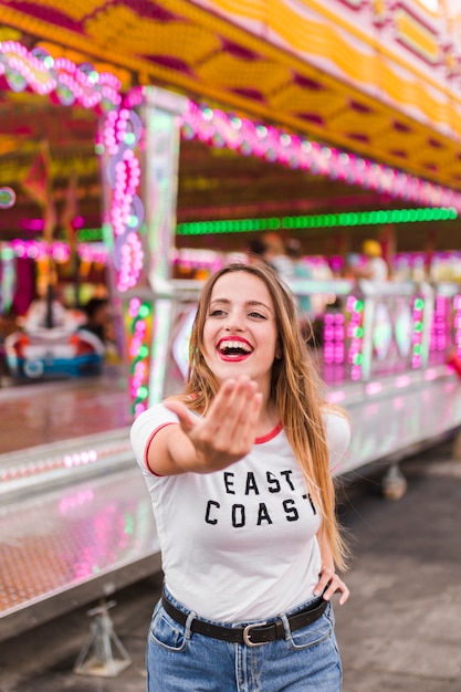 Blonde young girl in the amusement park