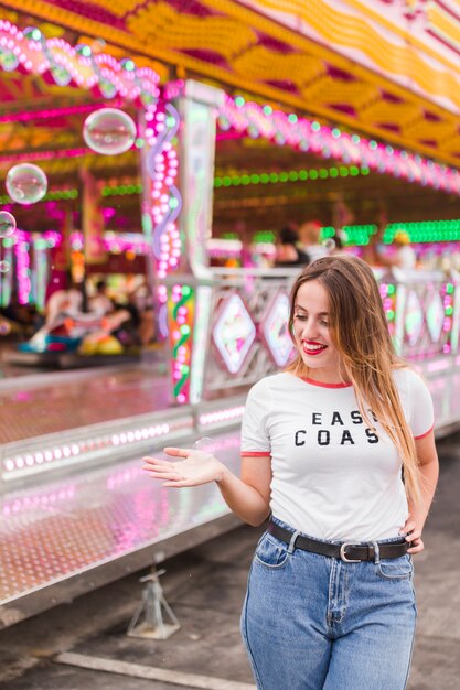 Blonde young girl in the amusement park