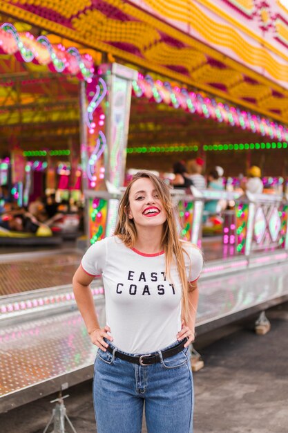 Blonde young girl in the amusement park