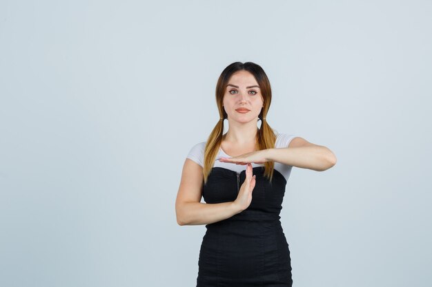 Blonde young lady in dress gesturing isolated