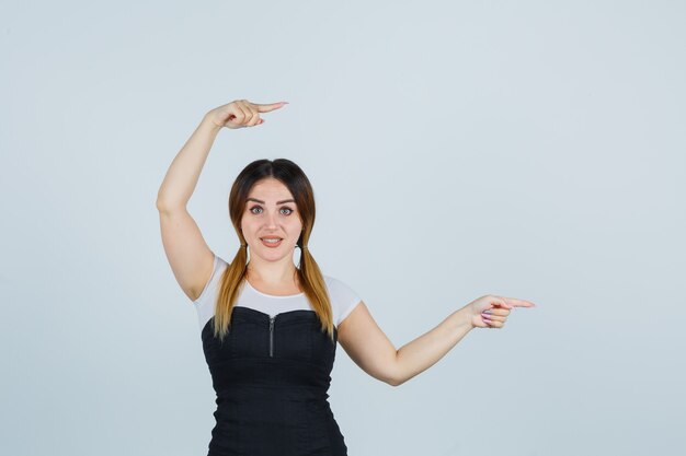 Blonde young lady in dress gesturing isolated