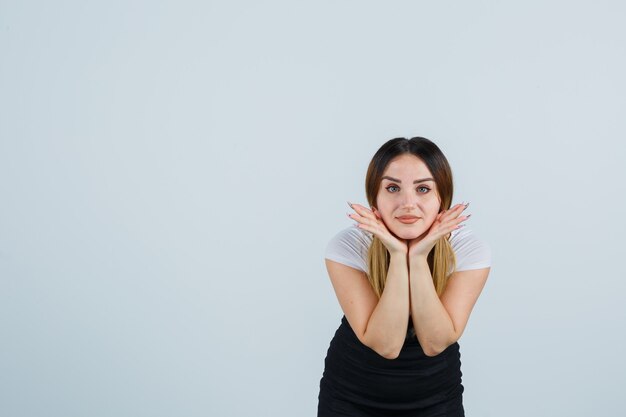 Blonde young lady in dress gesturing isolated