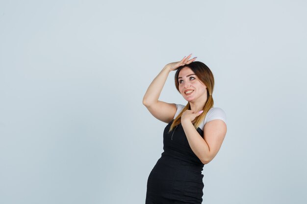 Blonde young lady in dress gesturing isolated