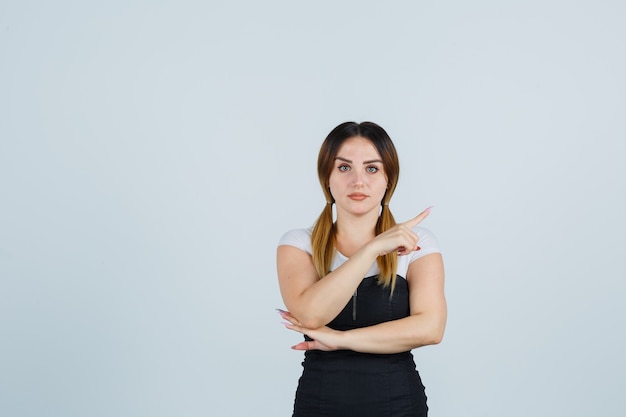 Blonde young lady in dress gesturing isolated