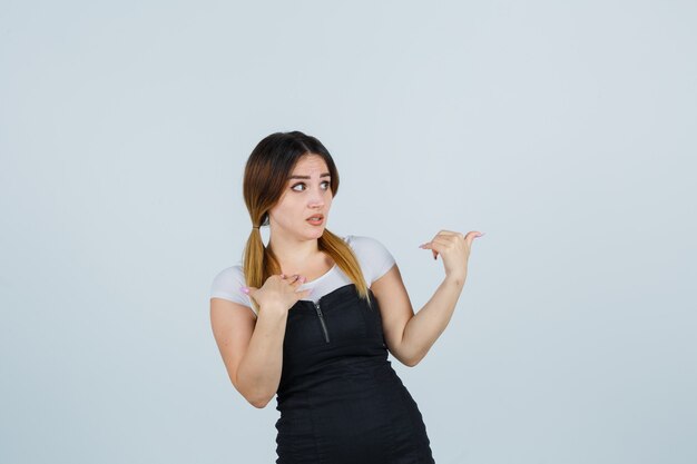 Blonde young lady in dress gesturing isolated