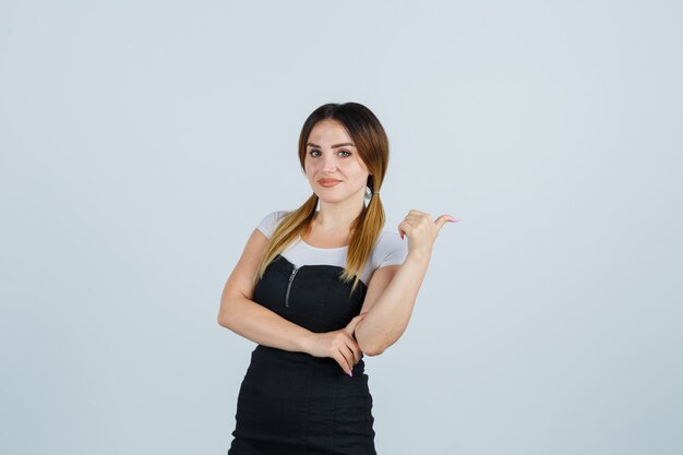 Blonde young lady in dress gesturing isolated