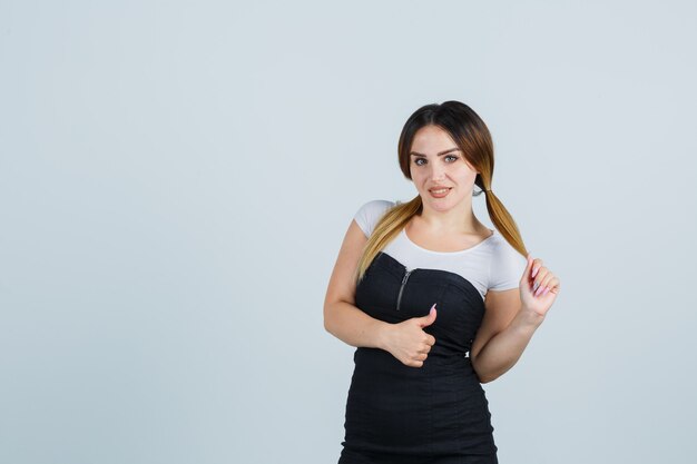 Blonde young lady in dress gesturing isolated