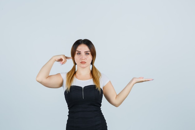 Blonde young lady in dress gesturing isolated