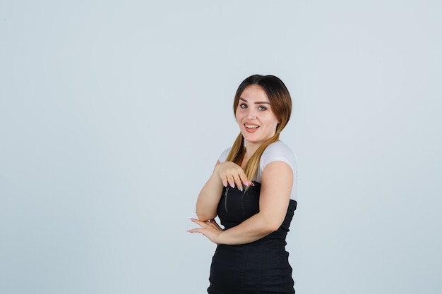 Blonde young lady in dress gesturing isolated