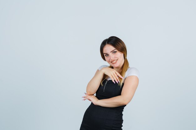 Blonde young lady in dress gesturing isolated