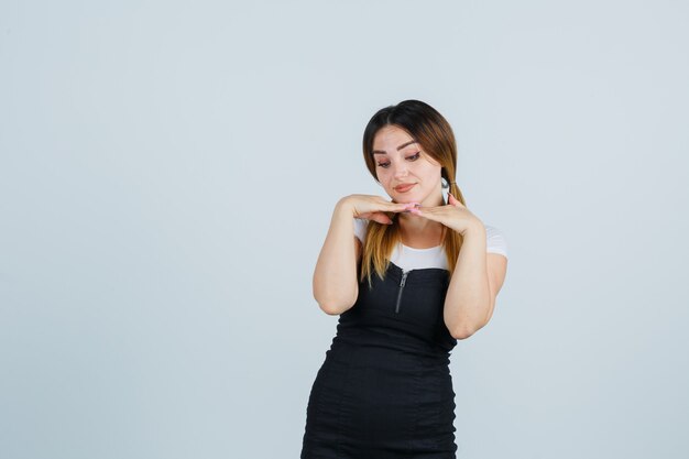 Blonde young lady in dress gesturing isolated