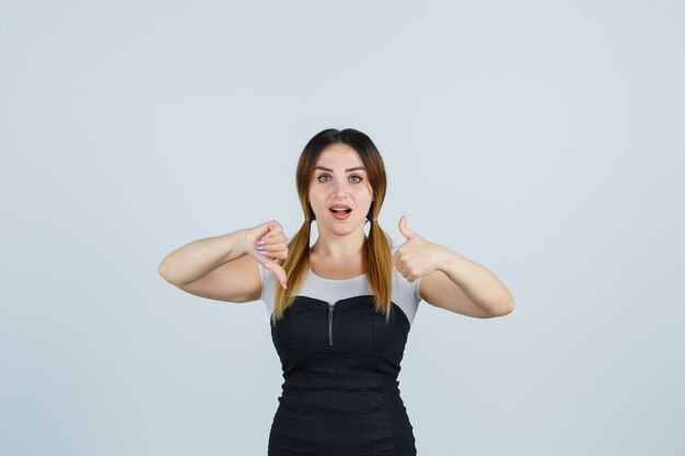 Blonde young lady in dress gesturing isolated