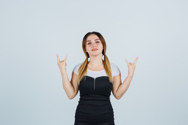 Blonde young lady in dress gesturing isolated