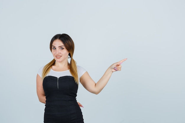 Blonde young lady in dress gesturing isolated