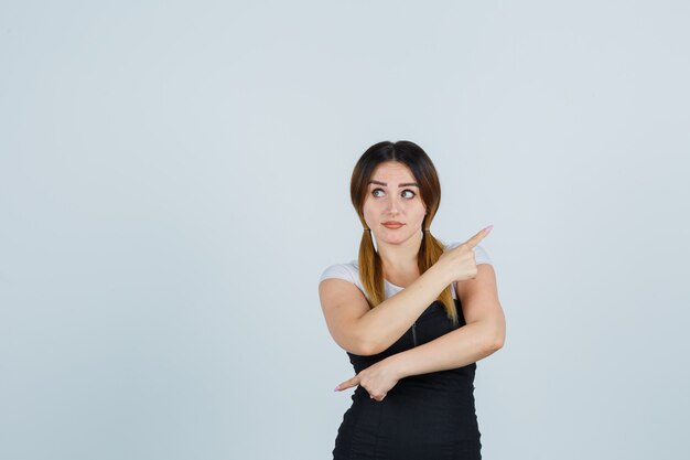 Blonde young lady in dress gesturing isolated