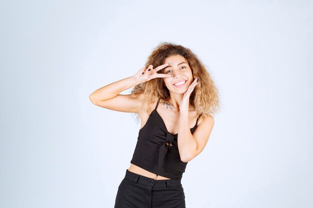 Blondie girl showing peace and friendship sign. 