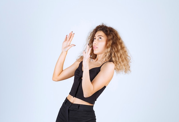 Free photo blondie woman feels emotional and stopping something.