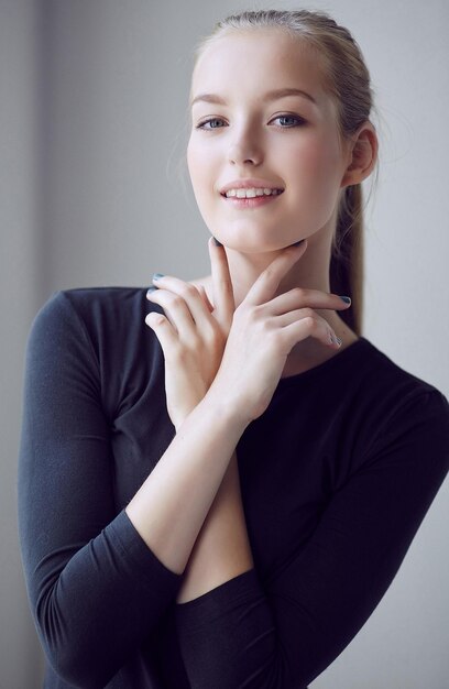 Free photo blondy young woman in a black dress.