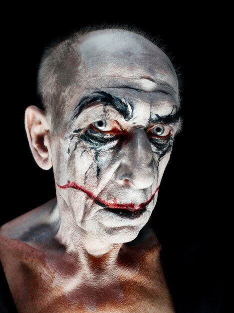 Bloody Halloween theme: The crazy maniak face on dark studio