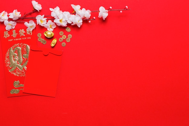 Цветущая ветка возле китайского конверта