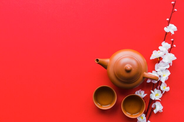 Blooming branch near tea set