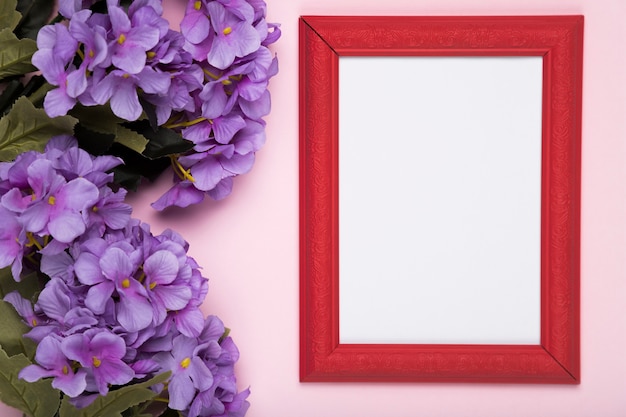 Free photo blooming flowers beside frame