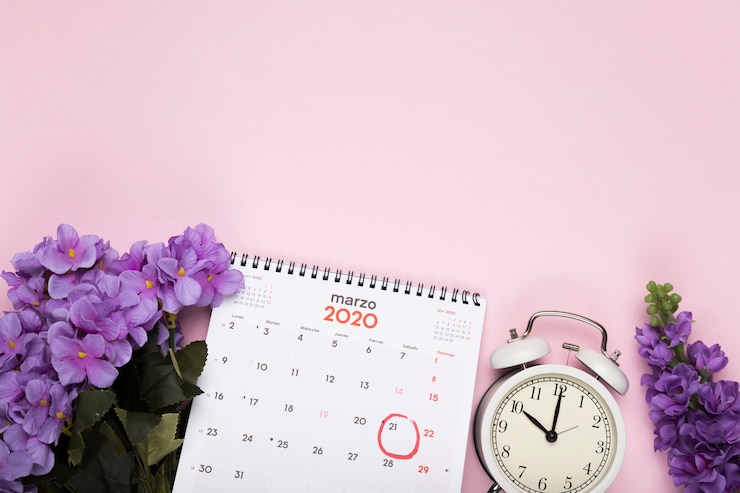 Free Photo blossom flowers with calendar and clock beside