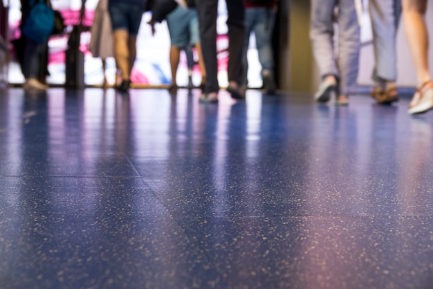 Blue airport floor with crown walking