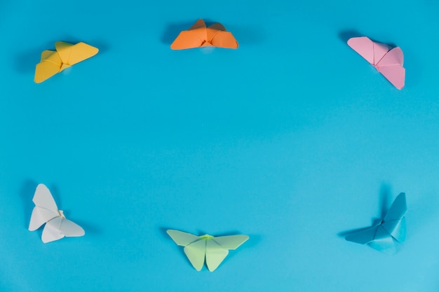 Free photo blue background with frame made of butterflies