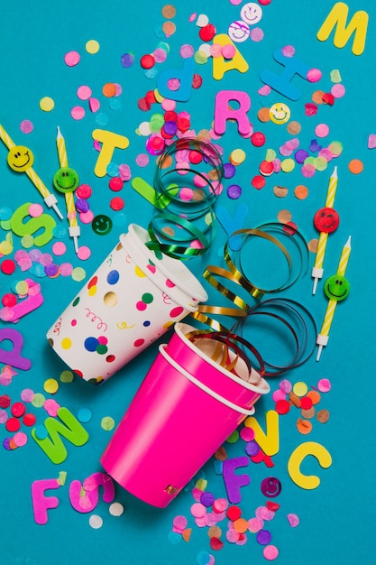 Blue background with glasses and party decoratio