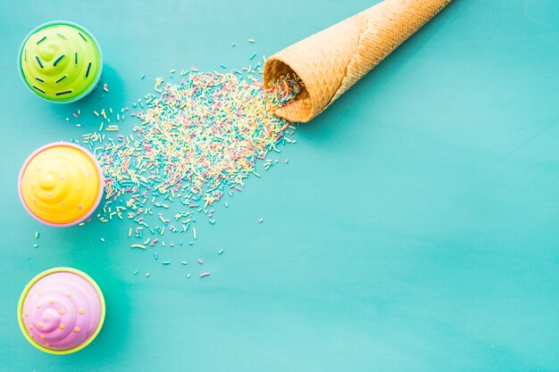 Blue background with ice cream cone and cupcakes