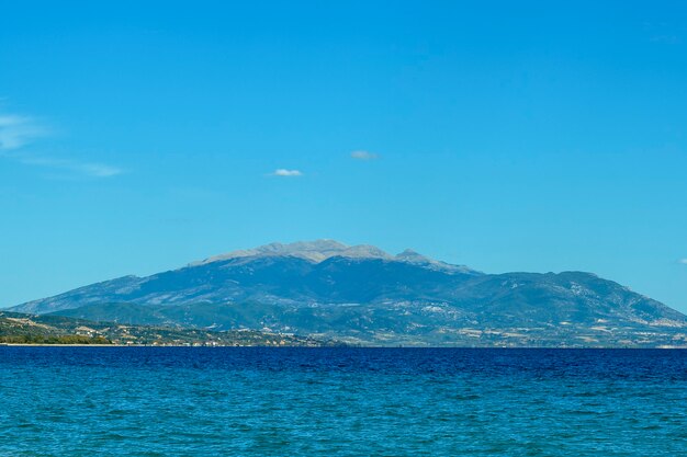Blue background with mountains and sea in Greece