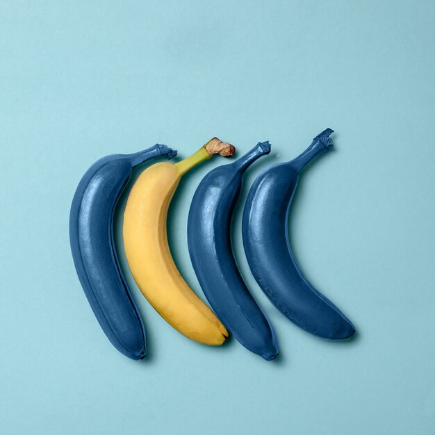 Blue bananas line with one clean banana