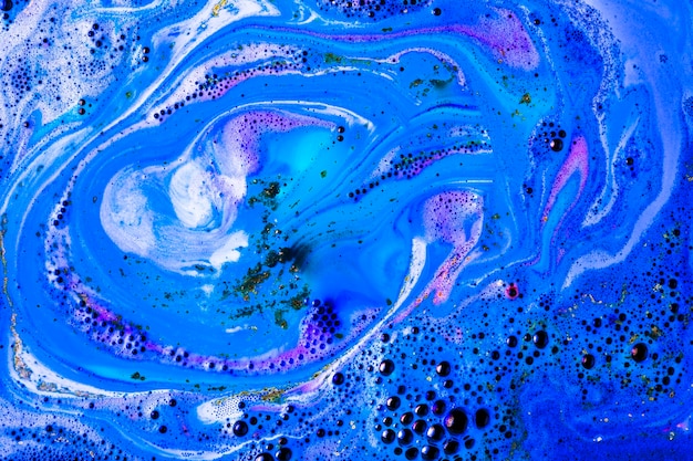 Blue bathbomb dissolve in bubble bath water