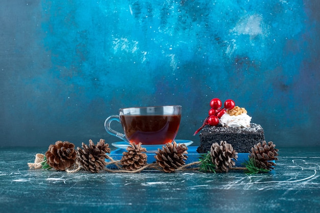초콜릿 케이크 한 조각과 차 한 잔이 있는 블루 보드. 고품질 사진
