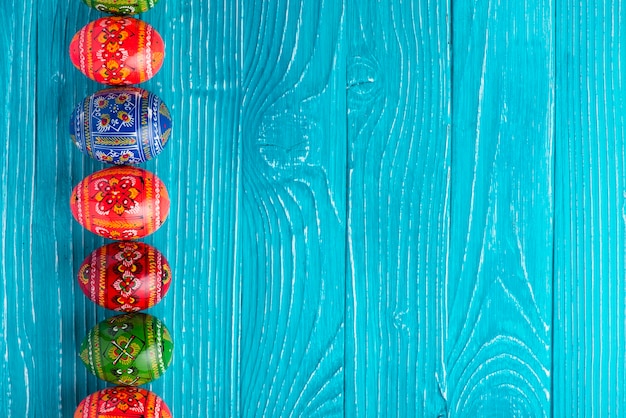 Blue boards with painted eggs for easter day