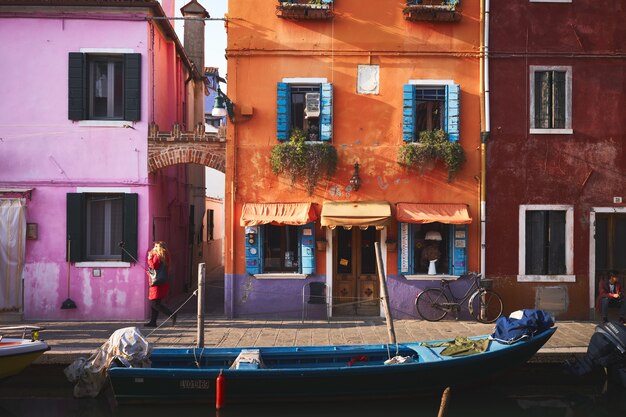 Blue boat on river near orange building