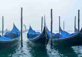 Foto gratuita barche blu parcheggiate e un cielo bianco e nebbioso