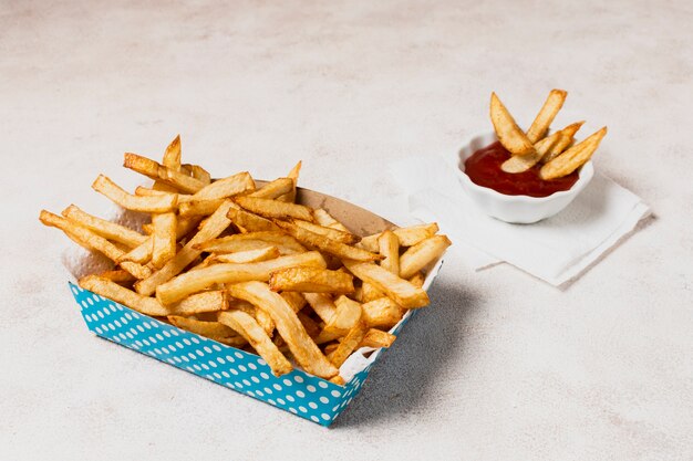 Blue box of french fries with ketchup