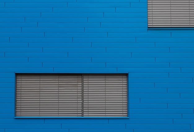 Blue brick wall with grey window blinders