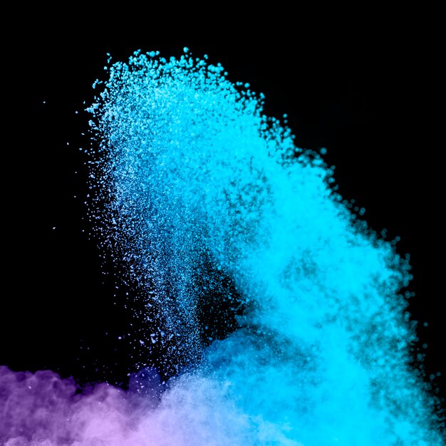 Blue burst of powder on dark background