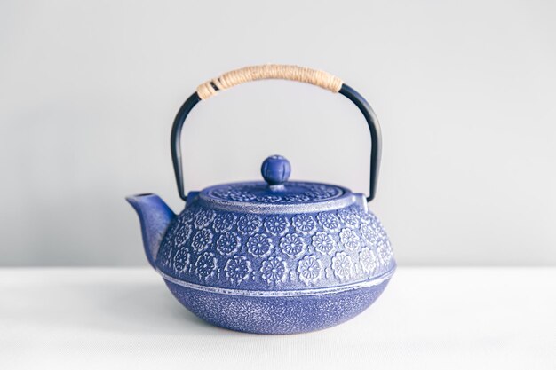 Blue cast iron teapot on a white background