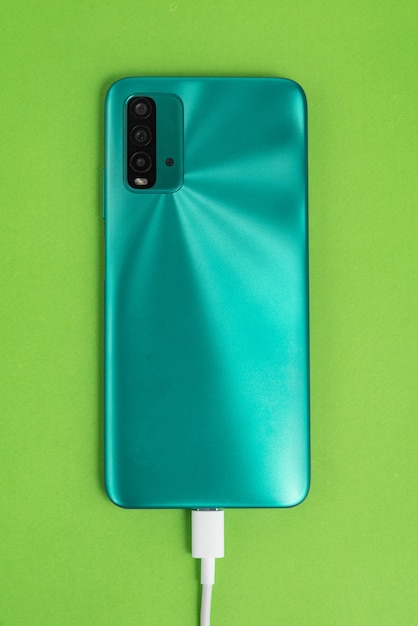 Blue cell phone connected to USB cable type C - Charging