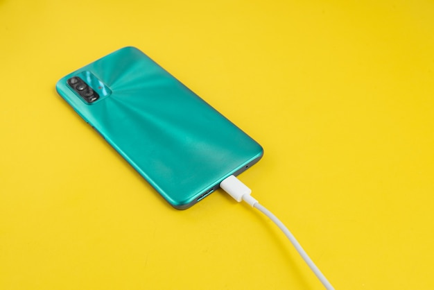 Blue cell phone connected to USB cable type C - Charging