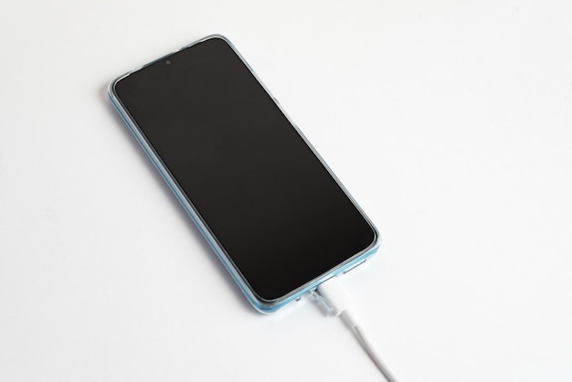 Blue cell phone connected to USB cable type C - Charging