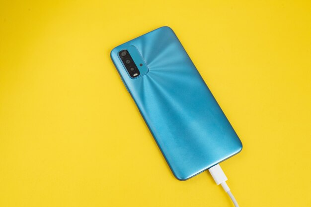 Blue cell phone connected to USB cable type C - Charging