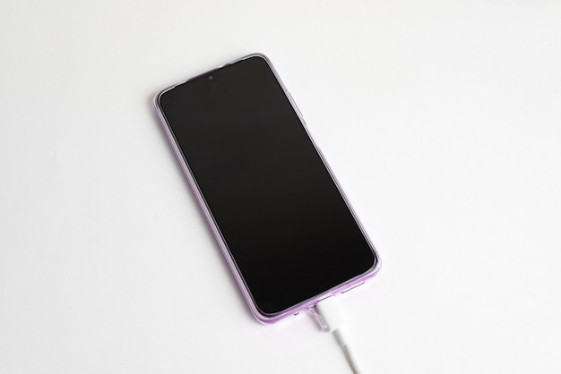 Blue cell phone connected to USB cable type C - Charging