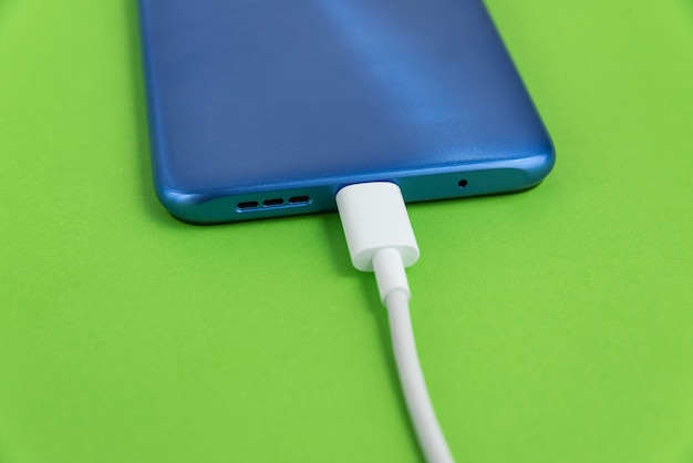 Free photo blue cell phone connected to usb cable type - charging