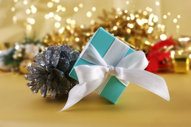 Blue Christmas gift on gold background